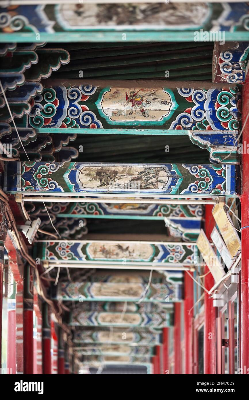Polychrome wooden crossbeams and rafters-colonnade ceiling-Ming Qing food street. Zhangye-Gansu-China-1314 Stock Photo