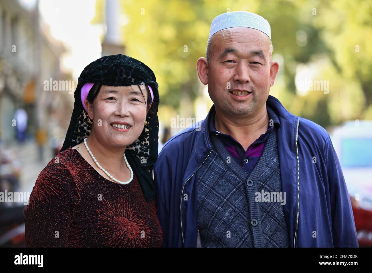 Middle aged couple-Hui muslim minority-ethnic headgears. Ming and Qing street-Zhangye-Gansu-China-1317 Stock Photo