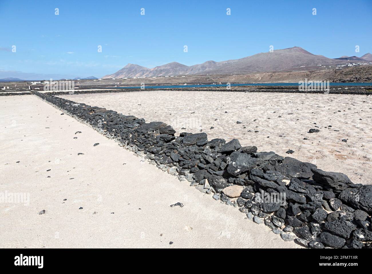 Dry wall made from volcanic rock in dry salt pans, Salinas de Janubio, Lanzarote, Canary Islands, Spain Stock Photo