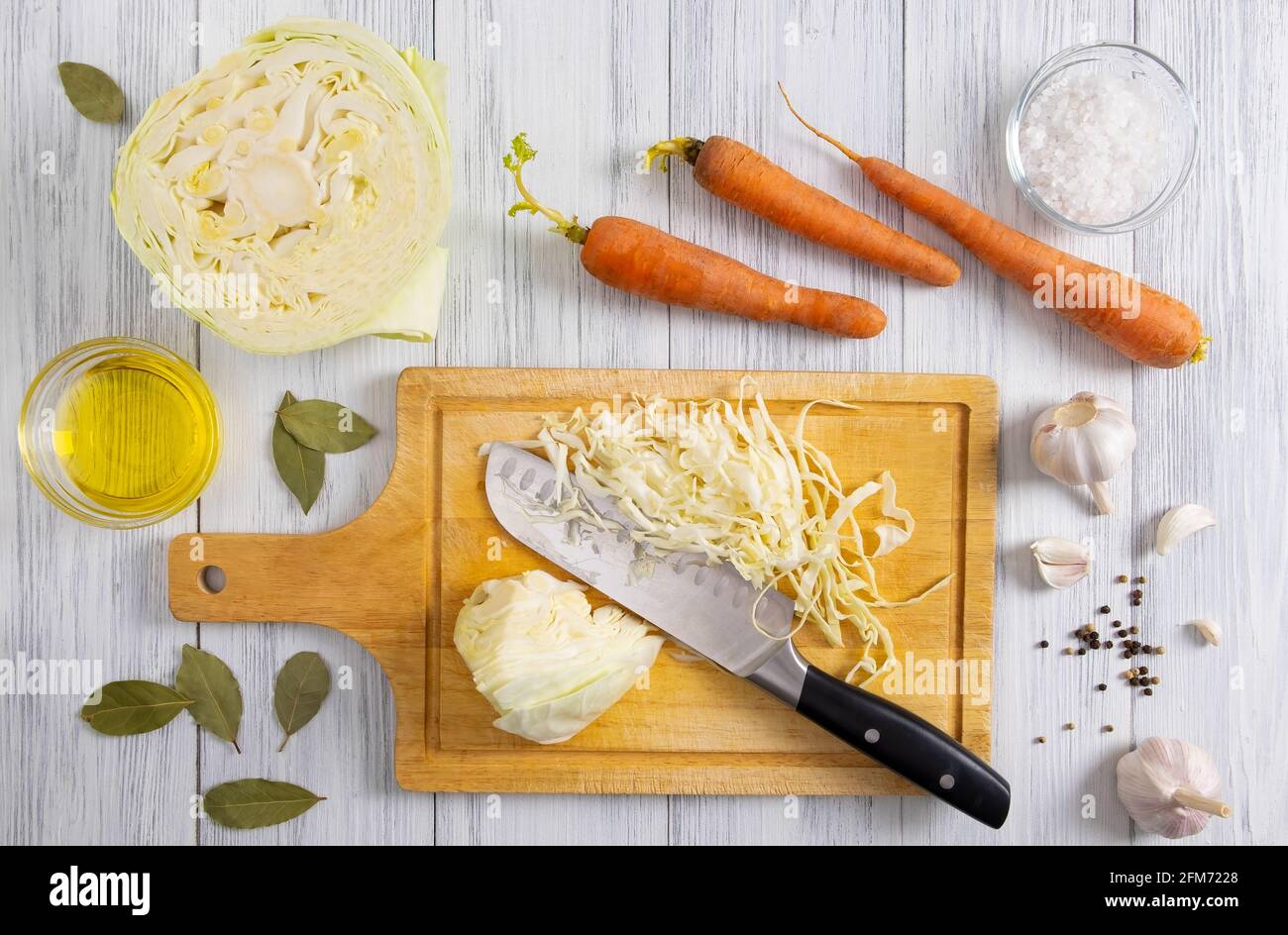 Kitchen workspace with white cabbage shredding process Stock Photo