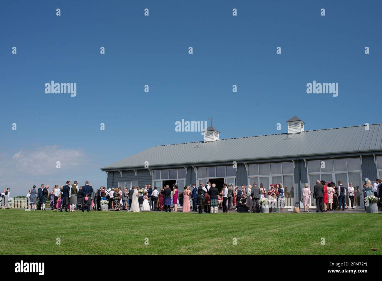 A wedding in progress at Barn of Barra Castle barn in high summer on a sunny day Stock Photo