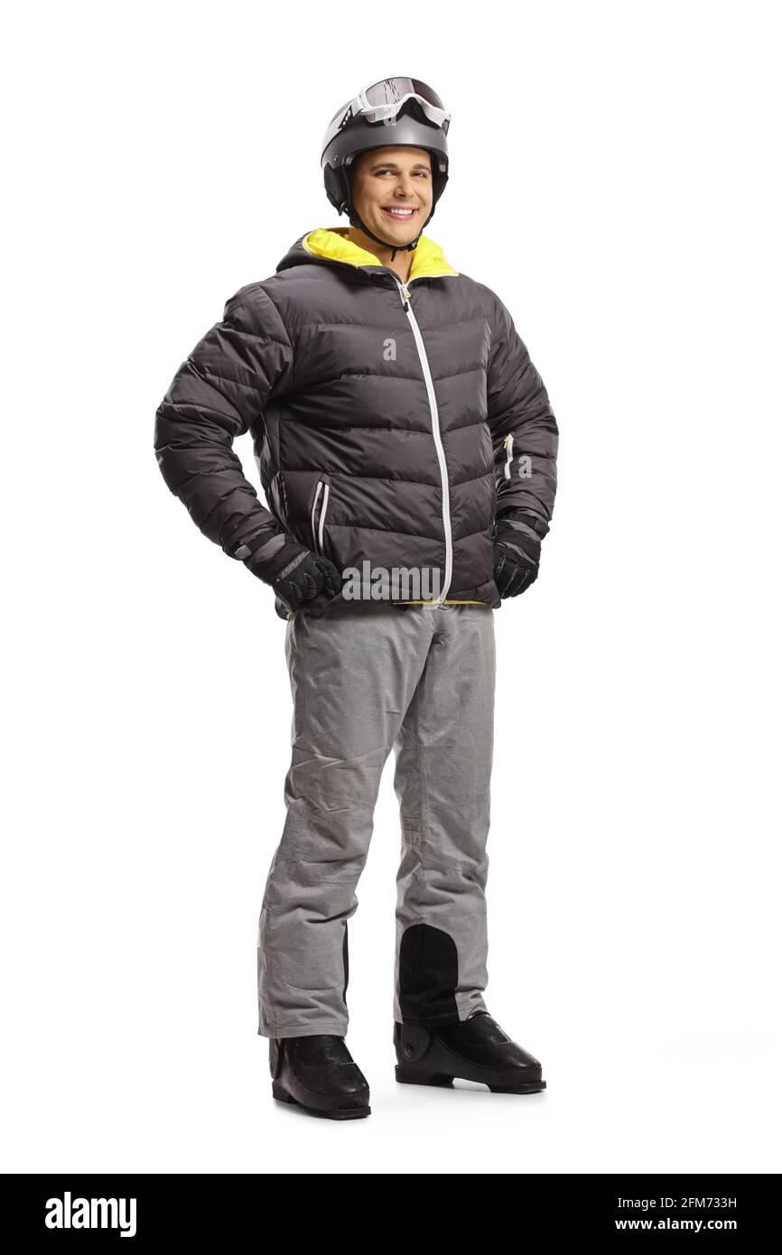 Full length portrait of a young man in a skiing jacket and boots isolated on a white background Stock Photo