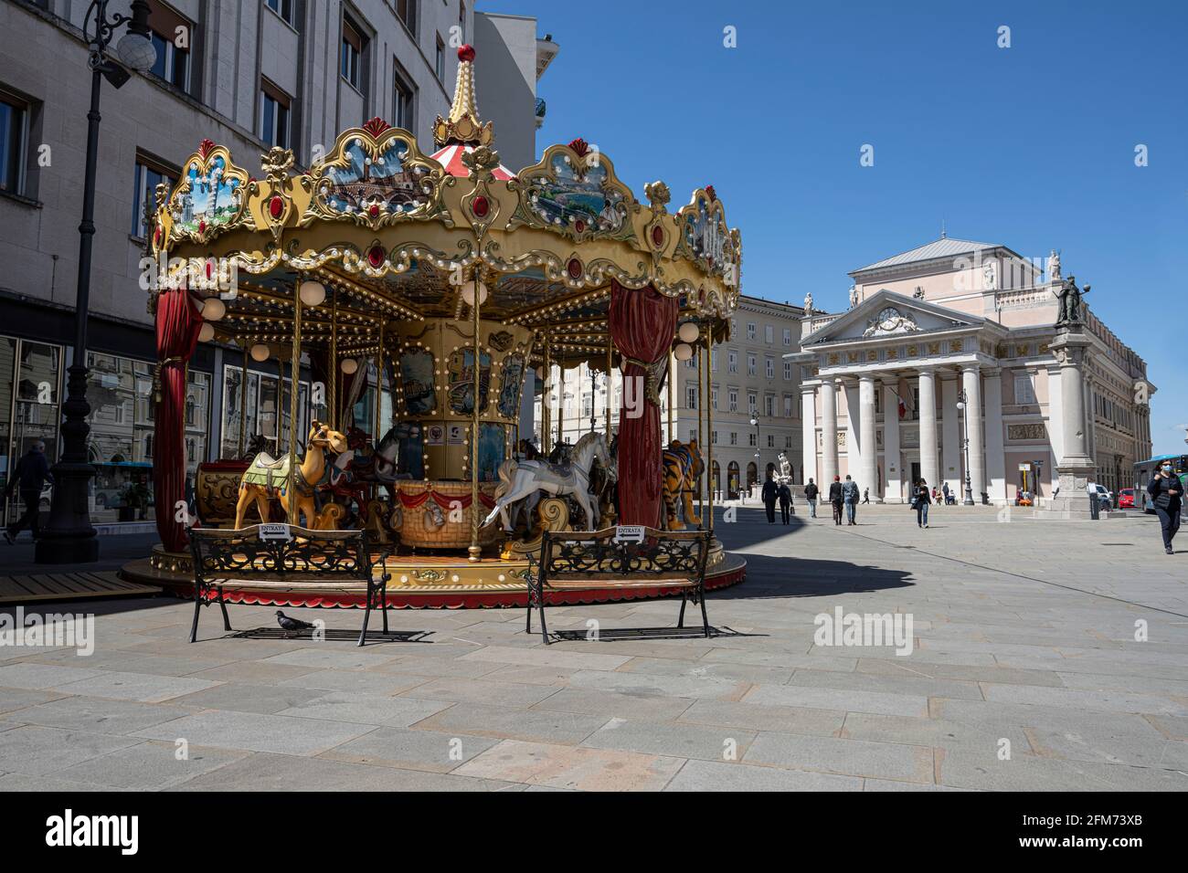 Trieste, Italy. May 3, 2021.  An old carousel for children in piazza della Borsa Stock Photo