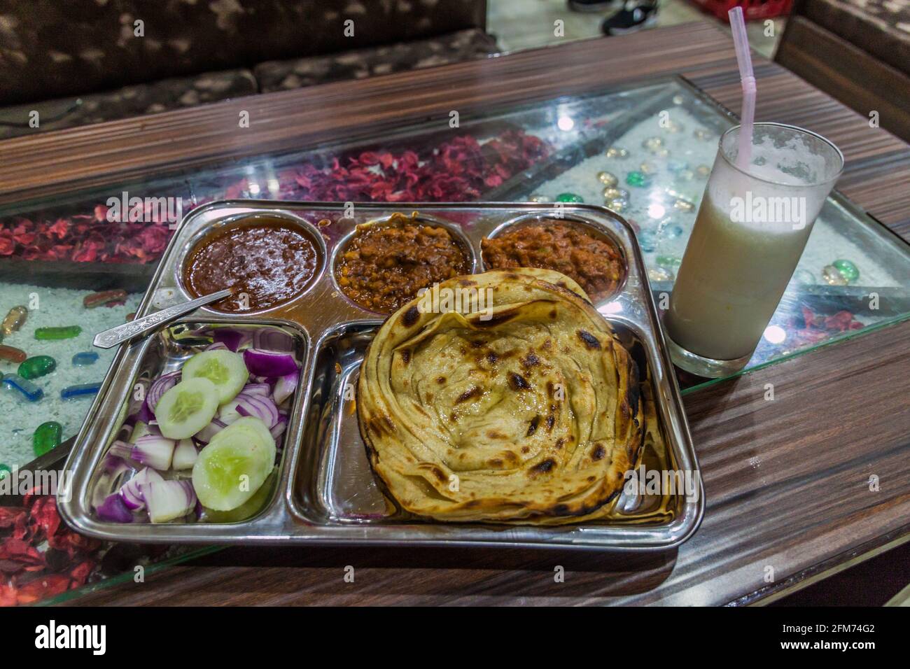 Traditional platter in Punjab Punjabi Thali , with a glass of lassi, Amritsar, India Stock Photo