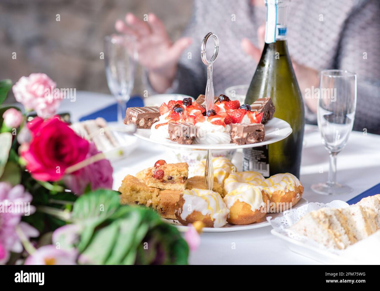 Afternoon tea buffet on cake stand with wine and scones Stock Photo