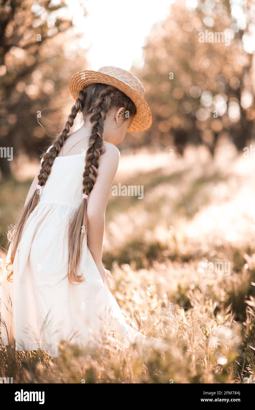 Stylish Kid Girl 4 5 Year Old Wearing Straw Hat And Elegant White Dress