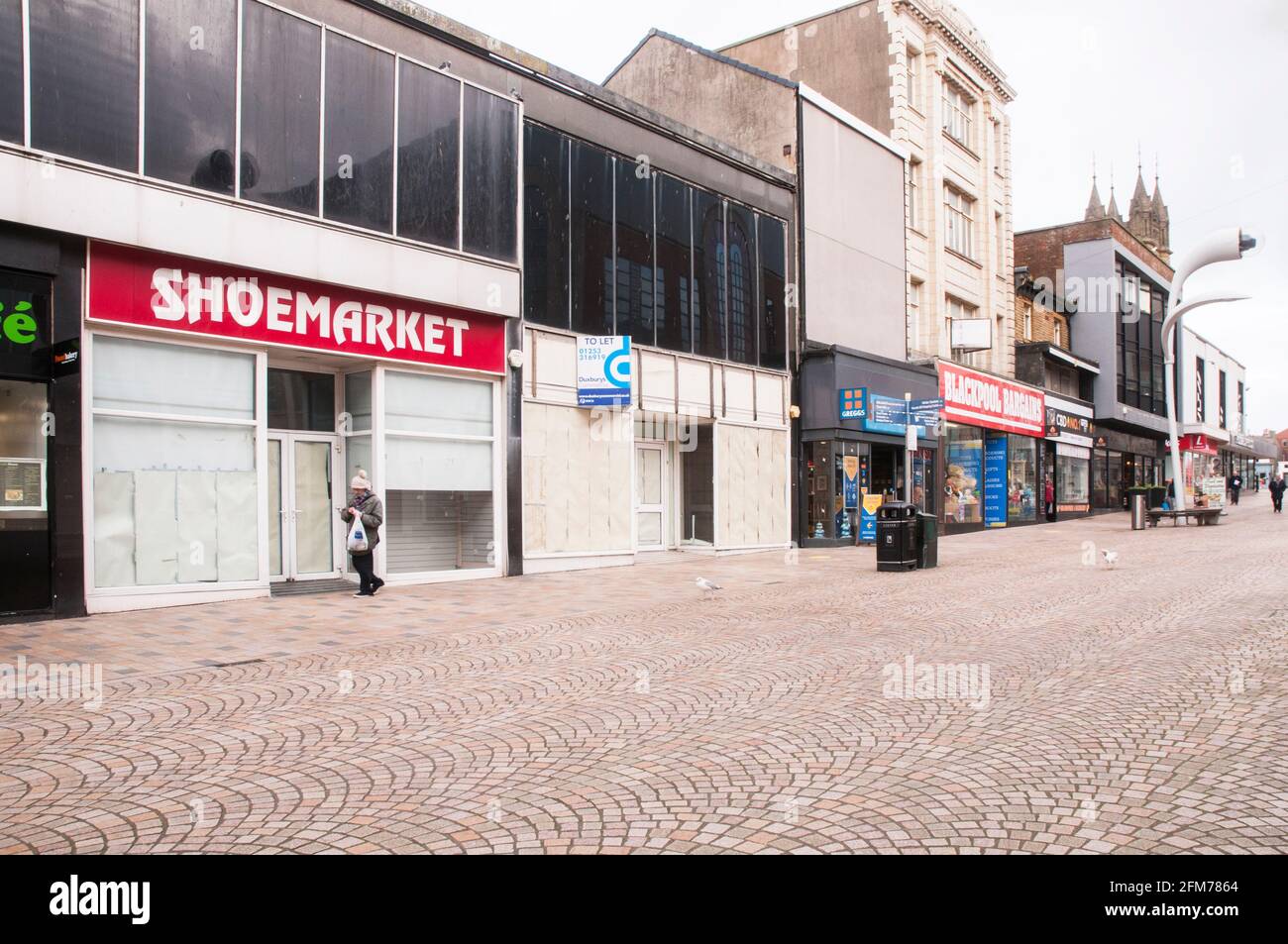 Closed and empty shops and almost deserted church street in town centre during Covid 19 lock down in Blackpool Lancashire England United Kingdom Stock Photo
