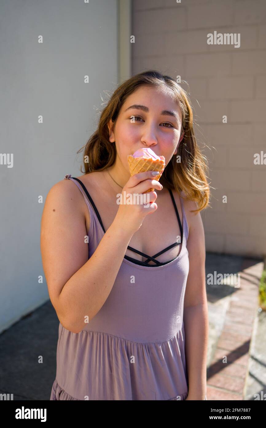 Petite Young Asian Woman Realistically Eating Rainbow Sherbet Ice Cream