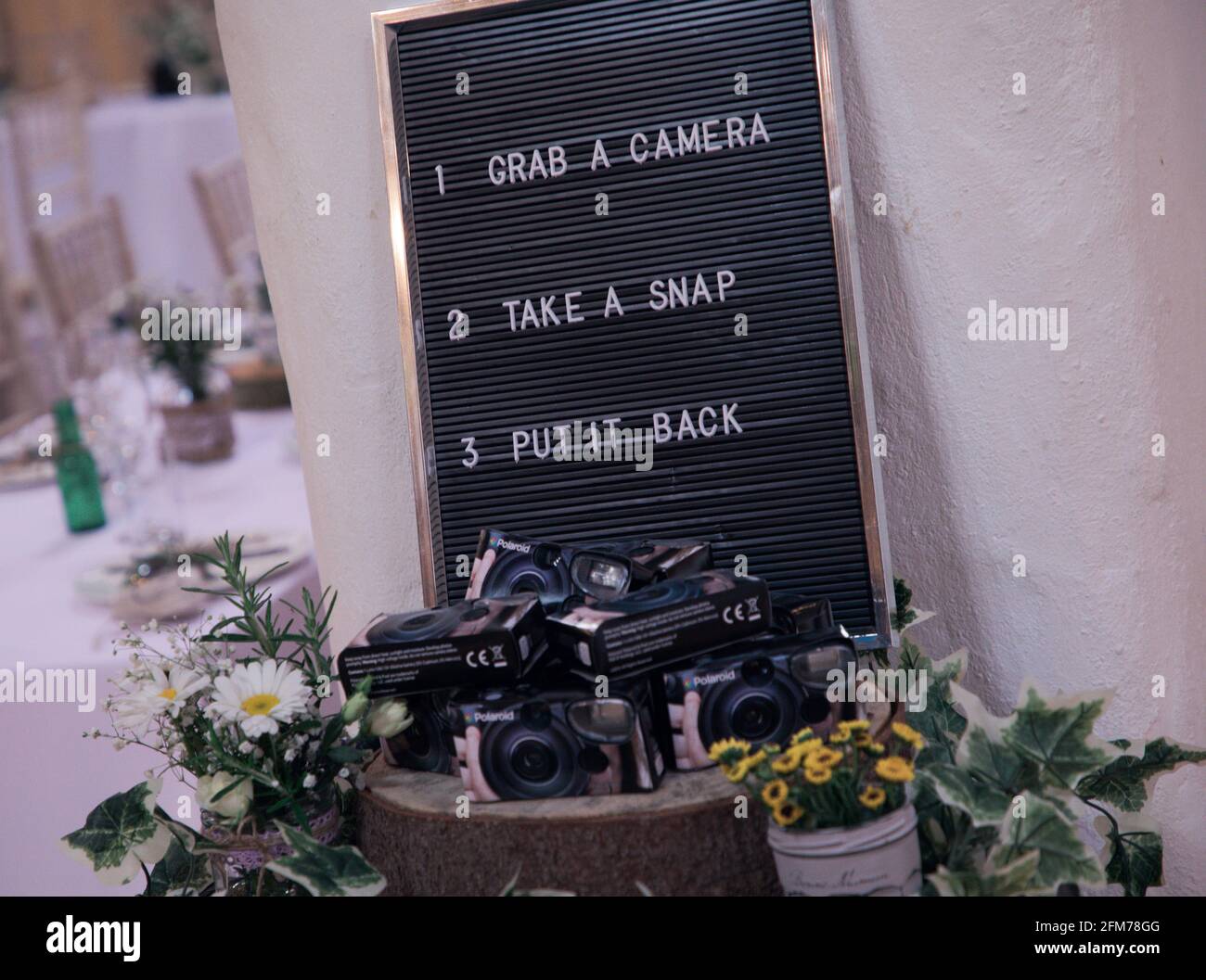 Instant cameras on display at a wedding for guest use Stock Photo Alamy