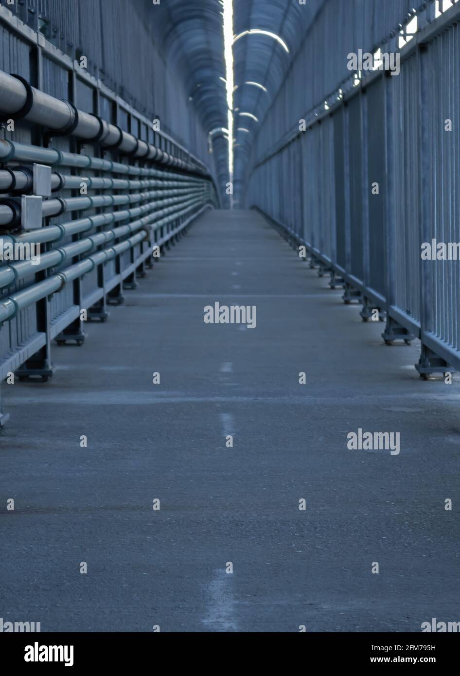 Low perspective view of the long and empty walkway on the Jacque Cartier bridge. Stock Photo