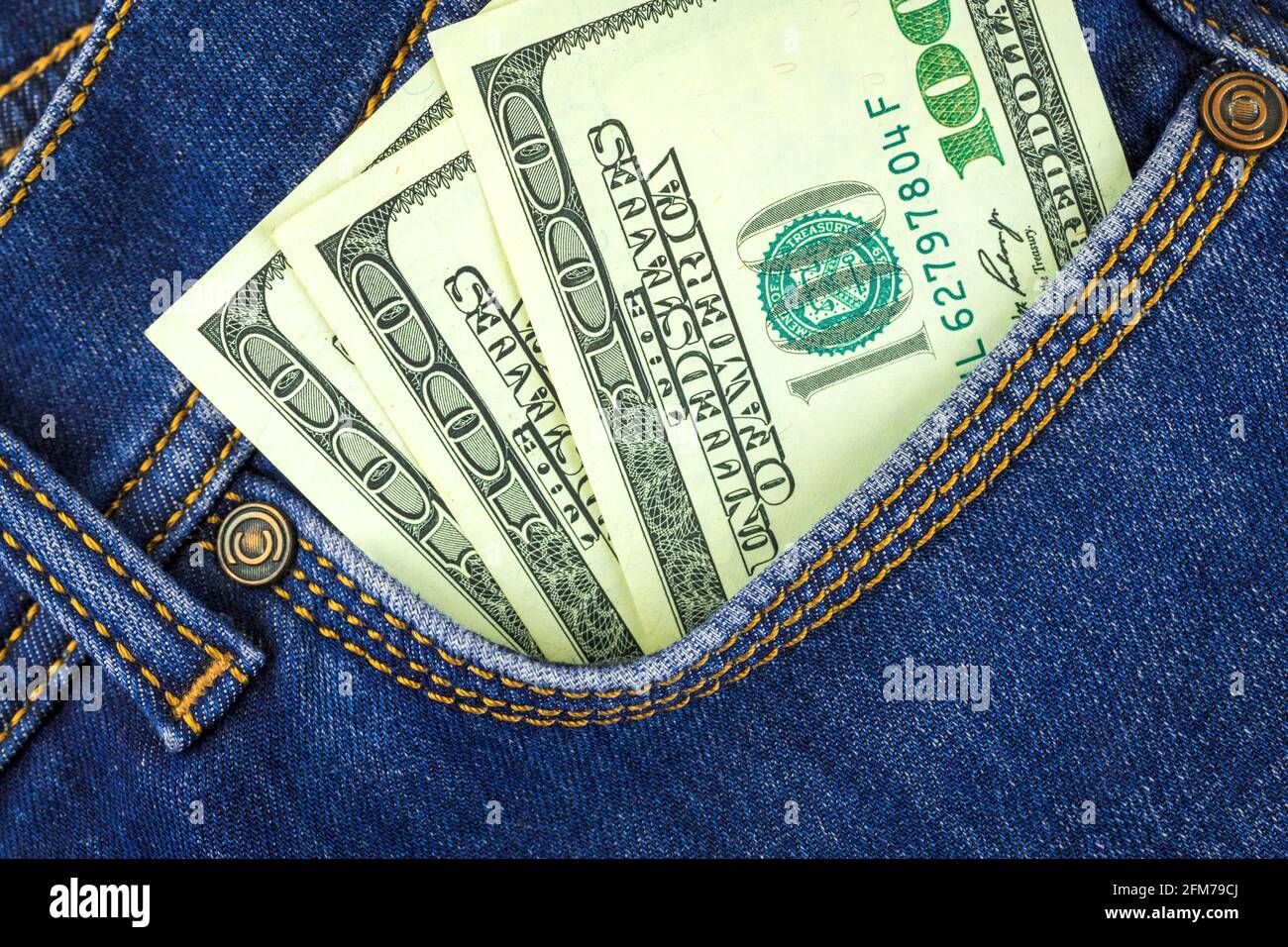 100 dollar banknotes in blue jeans pocket close up, business and finance background concept Stock Photo
