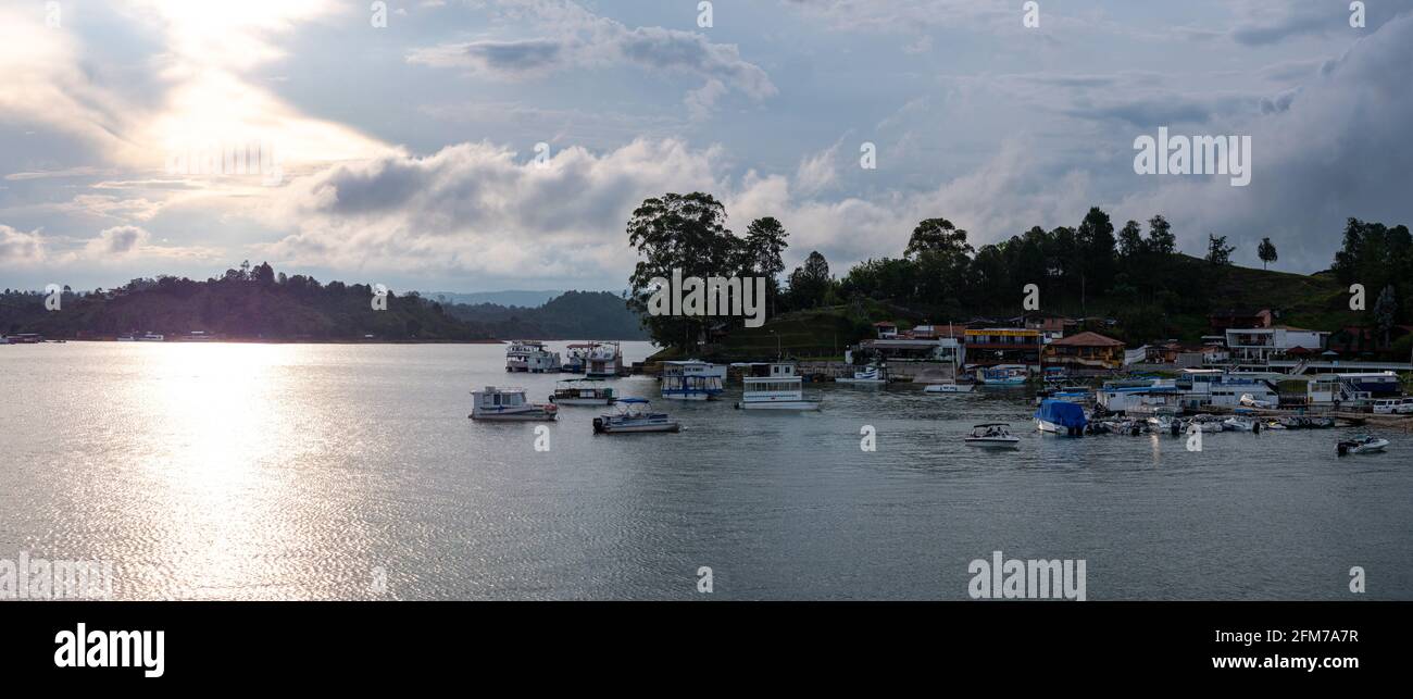 Guatapé, Antioquia, Colombia - April 3 2021: Panoramic View of Various Small Leisure Boats on the lake at Guatape Marina at Dusk Marina at Dusk Stock Photo