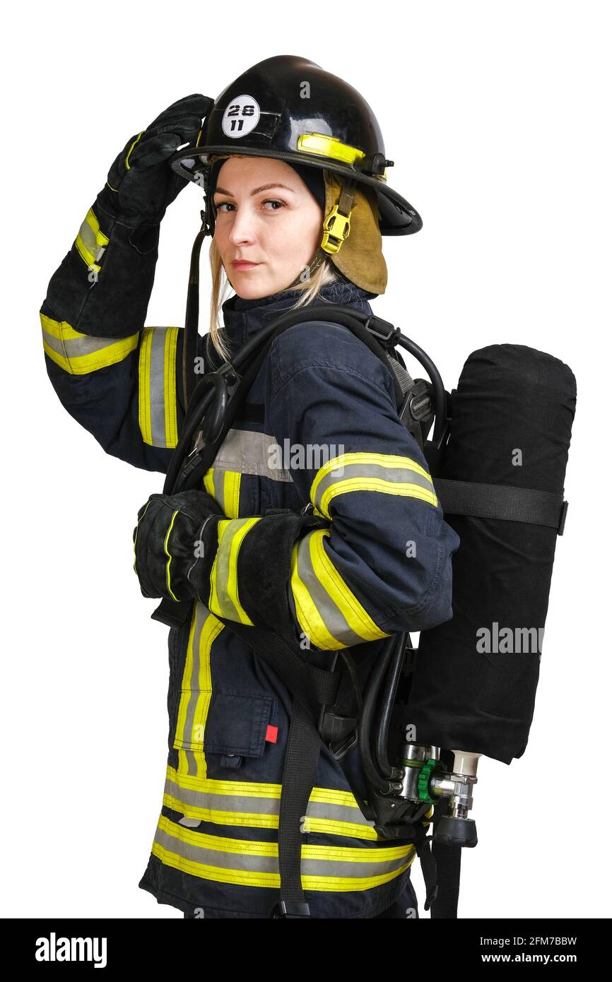 Woman in uniform of firefighter posing in profile with air tank Stock Photo