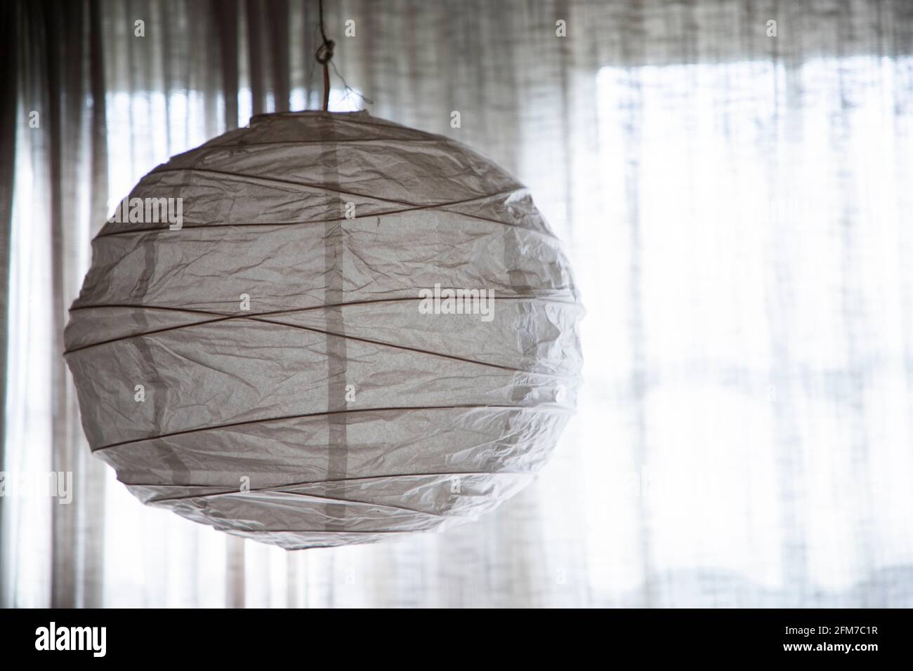 Paper lantern in window. Stock Photo