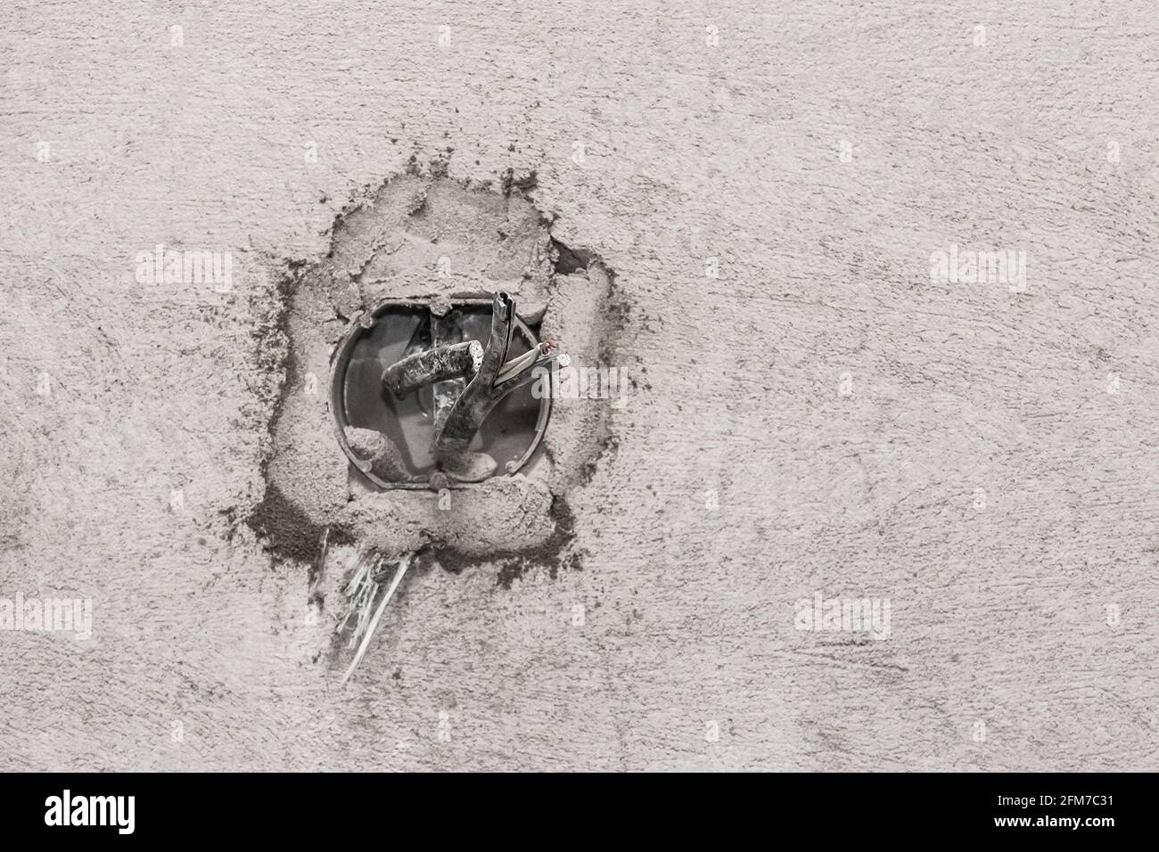 Niche for installing several electrical outlets on a gray concrete wall, home repair Stock Photo