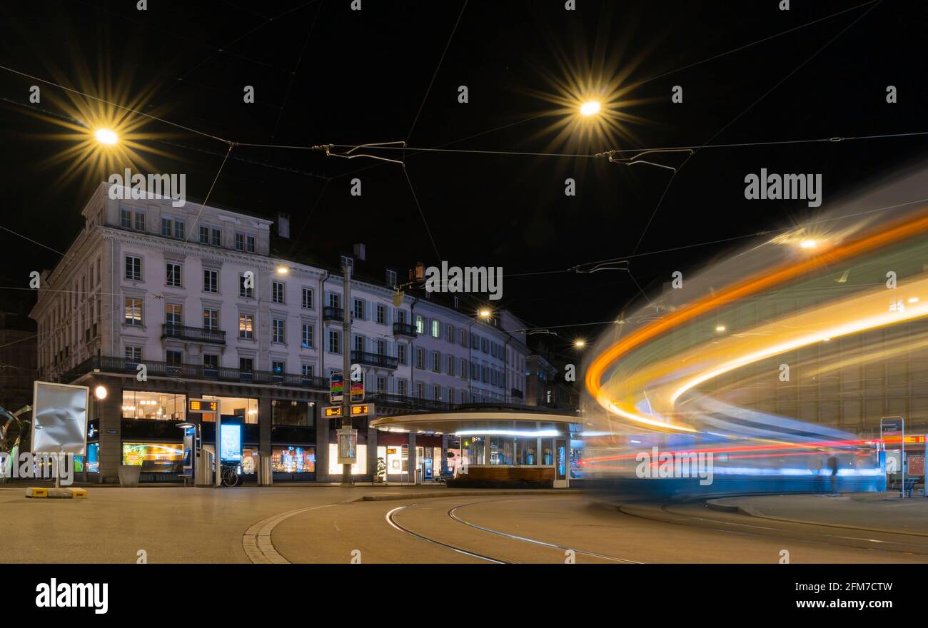 Light trails of a tram arriving at night at the square Paradeplatz in Zurich Stock Photo