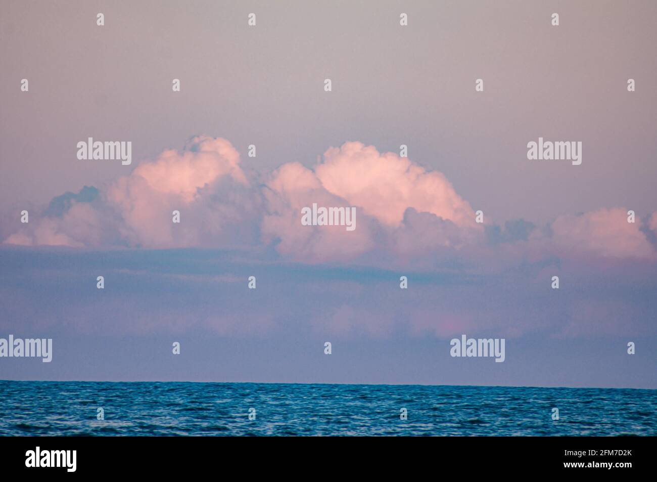 Beautiful shot of the sea under a cloudy sky in the evening Stock Photo ...