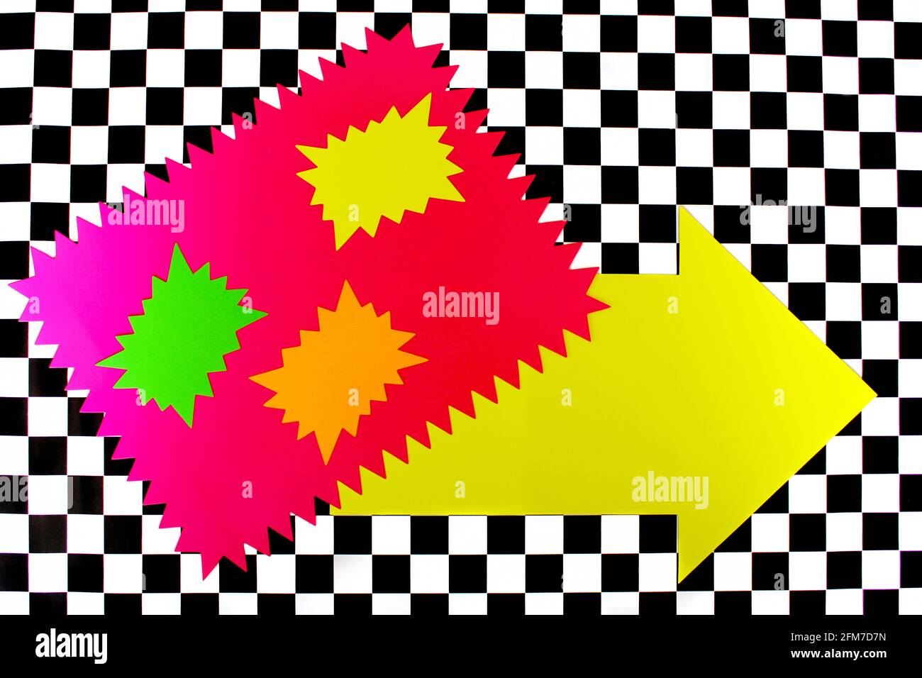 Photograph of Bright Neon Colored Shapes on Black and White Checkerboard pattern Stock Photo