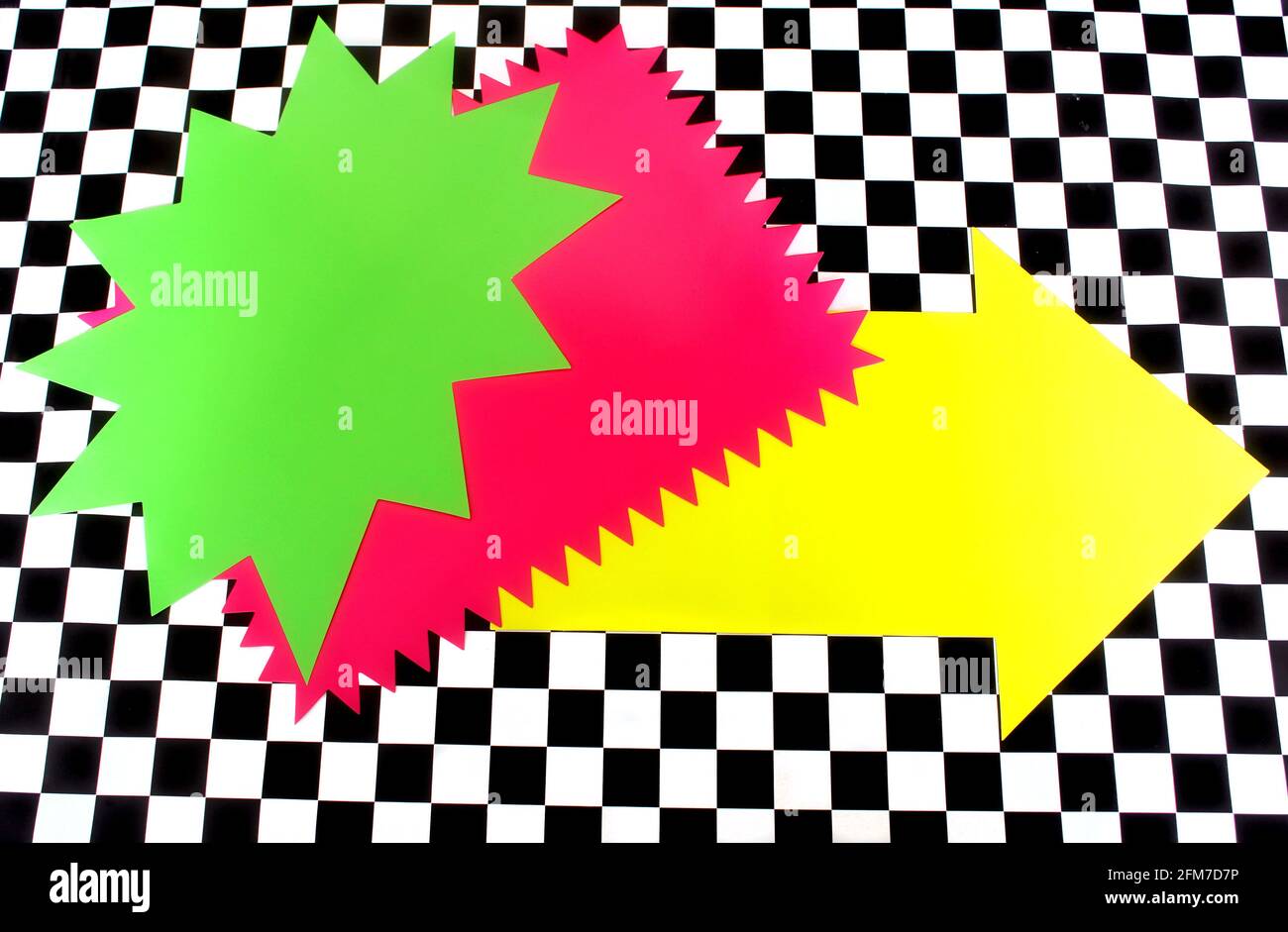 Photograph of Bright Neon Colored Shapes on Black and White Checkerboard pattern Stock Photo
