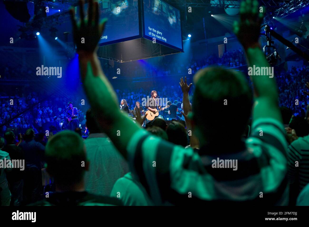 Christians praise God at an arena worship service in Atlanta, GA. Stock Photo