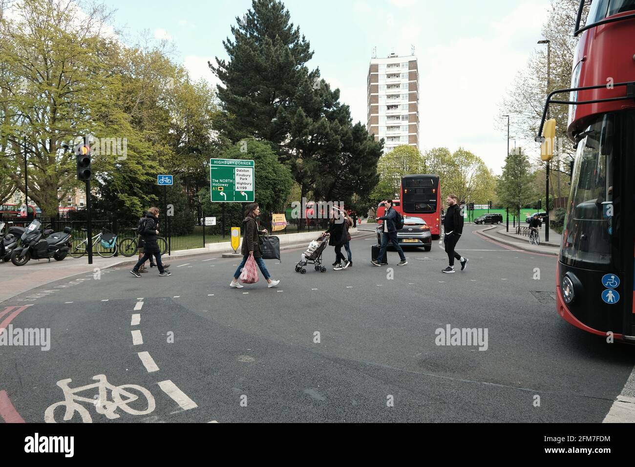 Pedestrians using the road crossing at Highbury Corner in Islington, London. Stock Photo