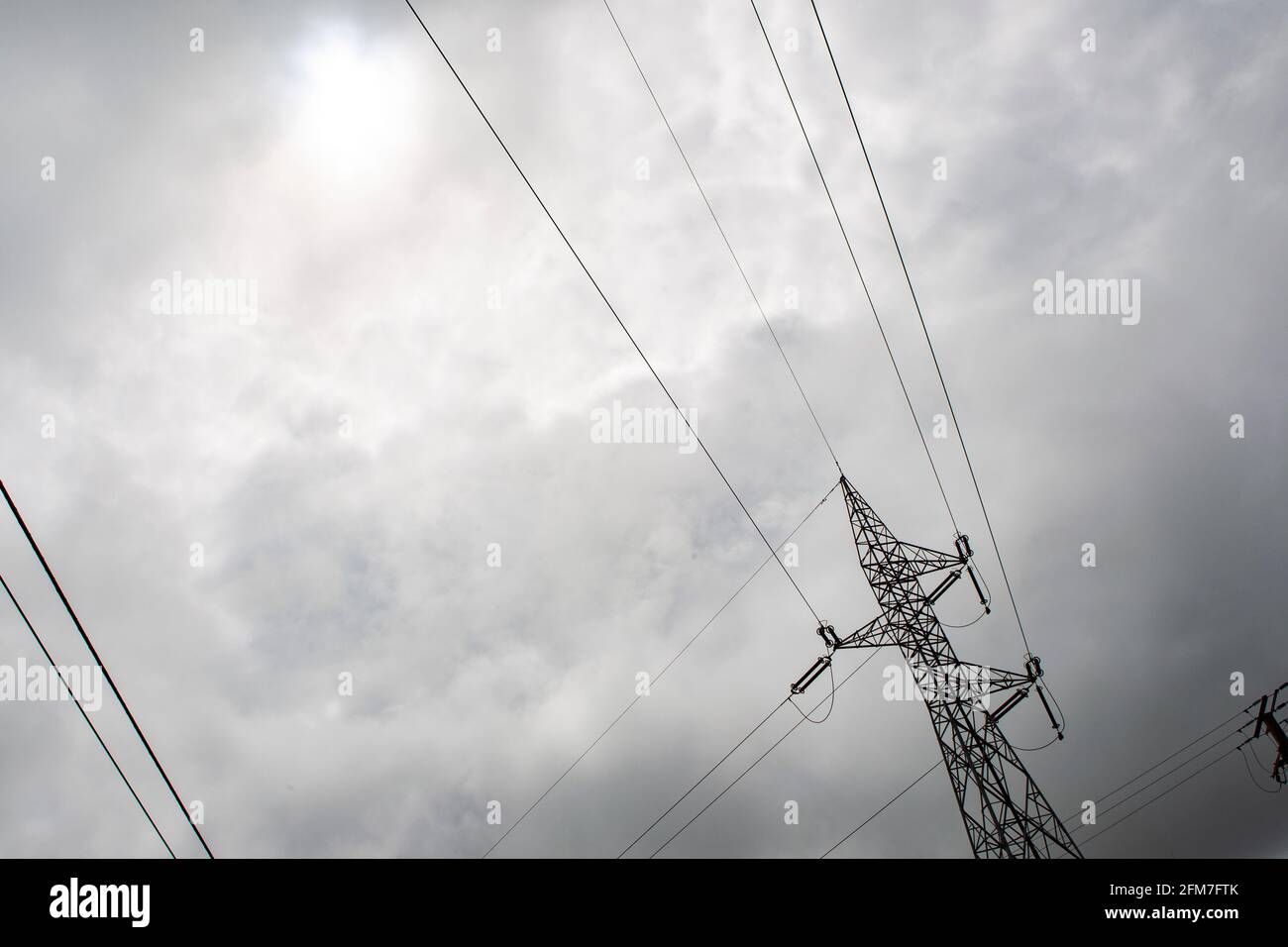 High voltage tower with stormy sky in the background Stock Photo - Alamy
