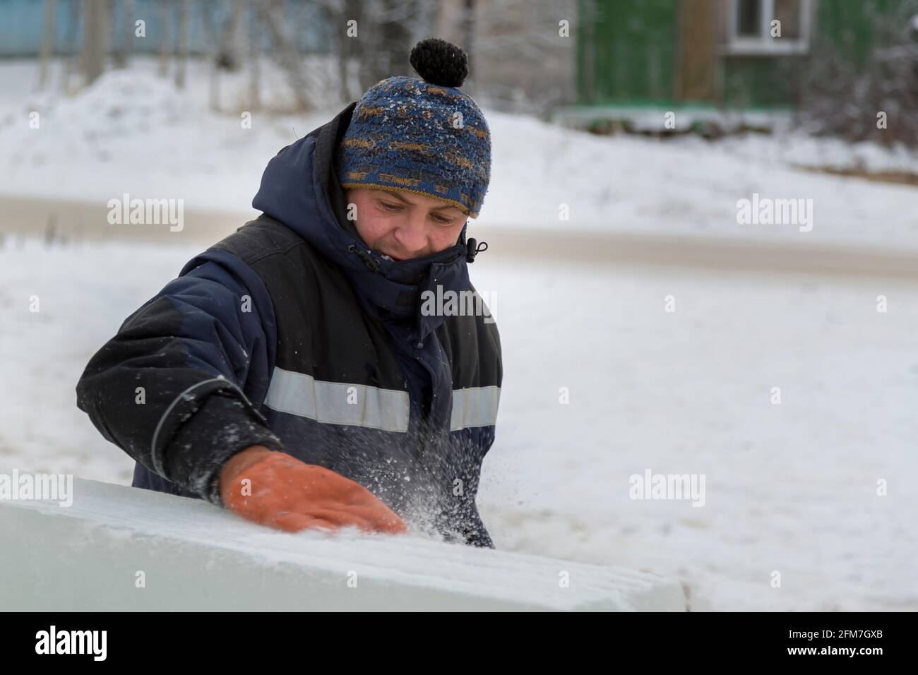 Portrait of a man in a blue winter jacket at the workplace Stock Photo