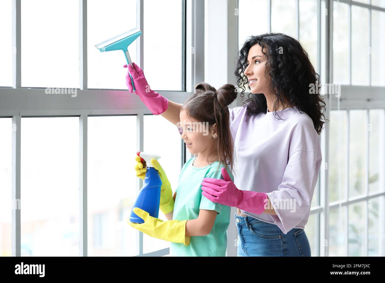 Mother and daughter cleaning window in their flat Stock Photo - Alamy