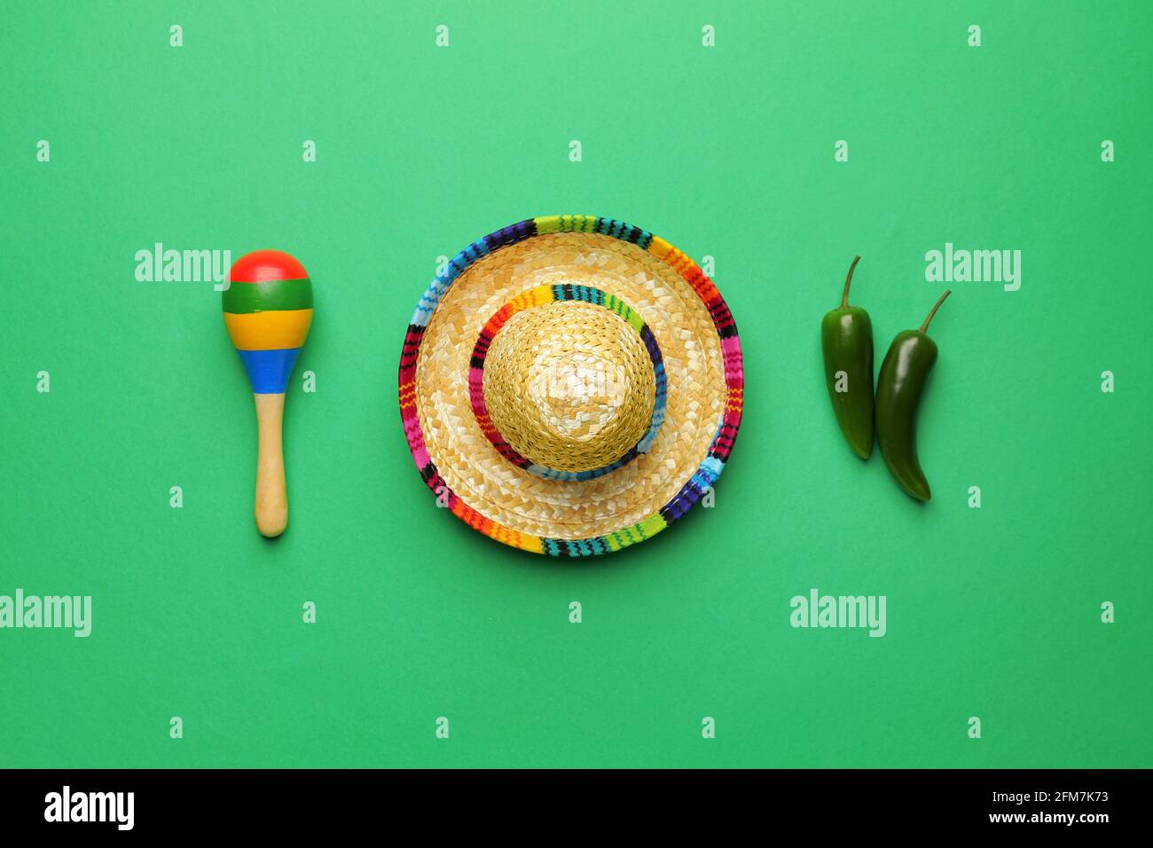 Mexican sombrero, maracas and chili peppers on color background Stock ...