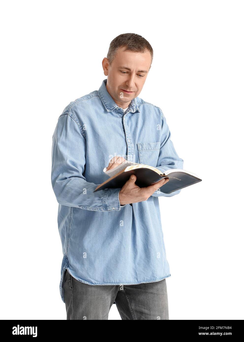 Man with Bible on white background Stock Photo