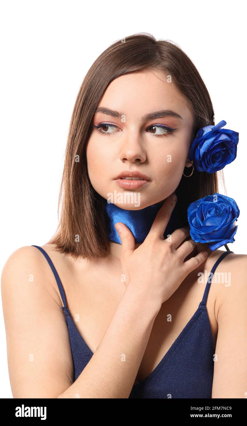 Beautiful young woman with blue roses on white background Stock Photo
