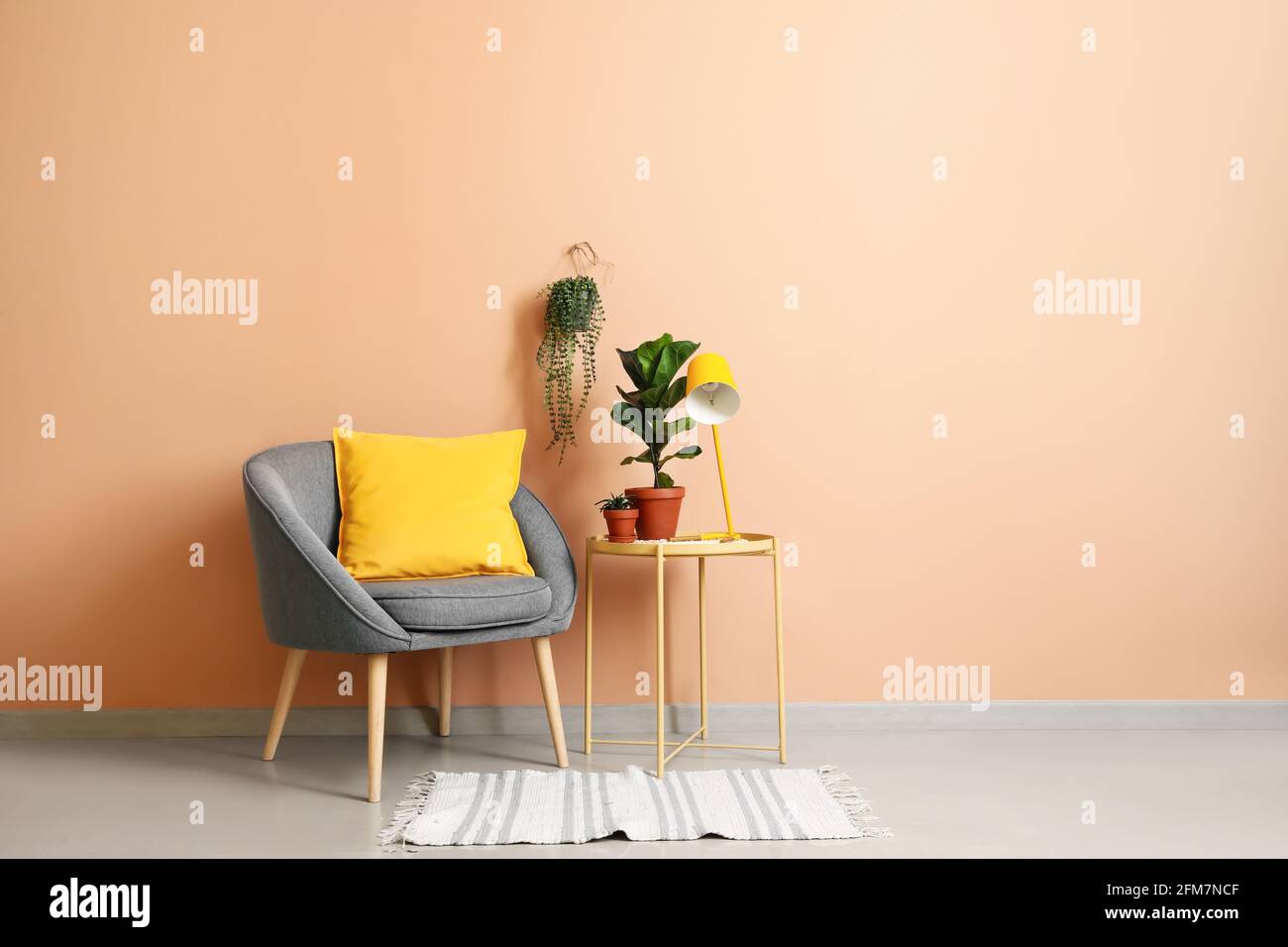 Interior of modern room with armchair and table Stock Photo - Alamy