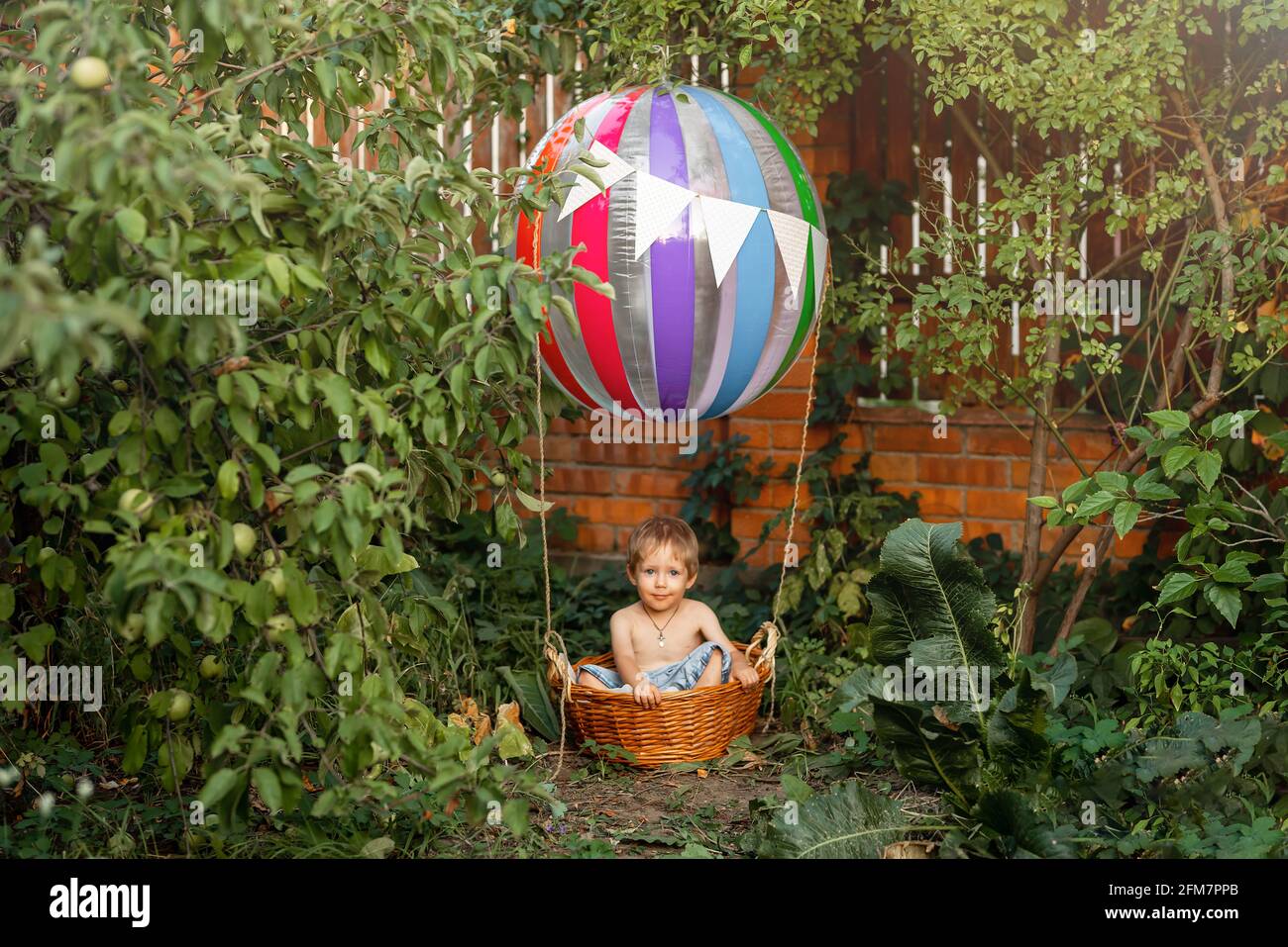 Cute child on hot air balloon. Kid riding hot air balloon. Stock Photo