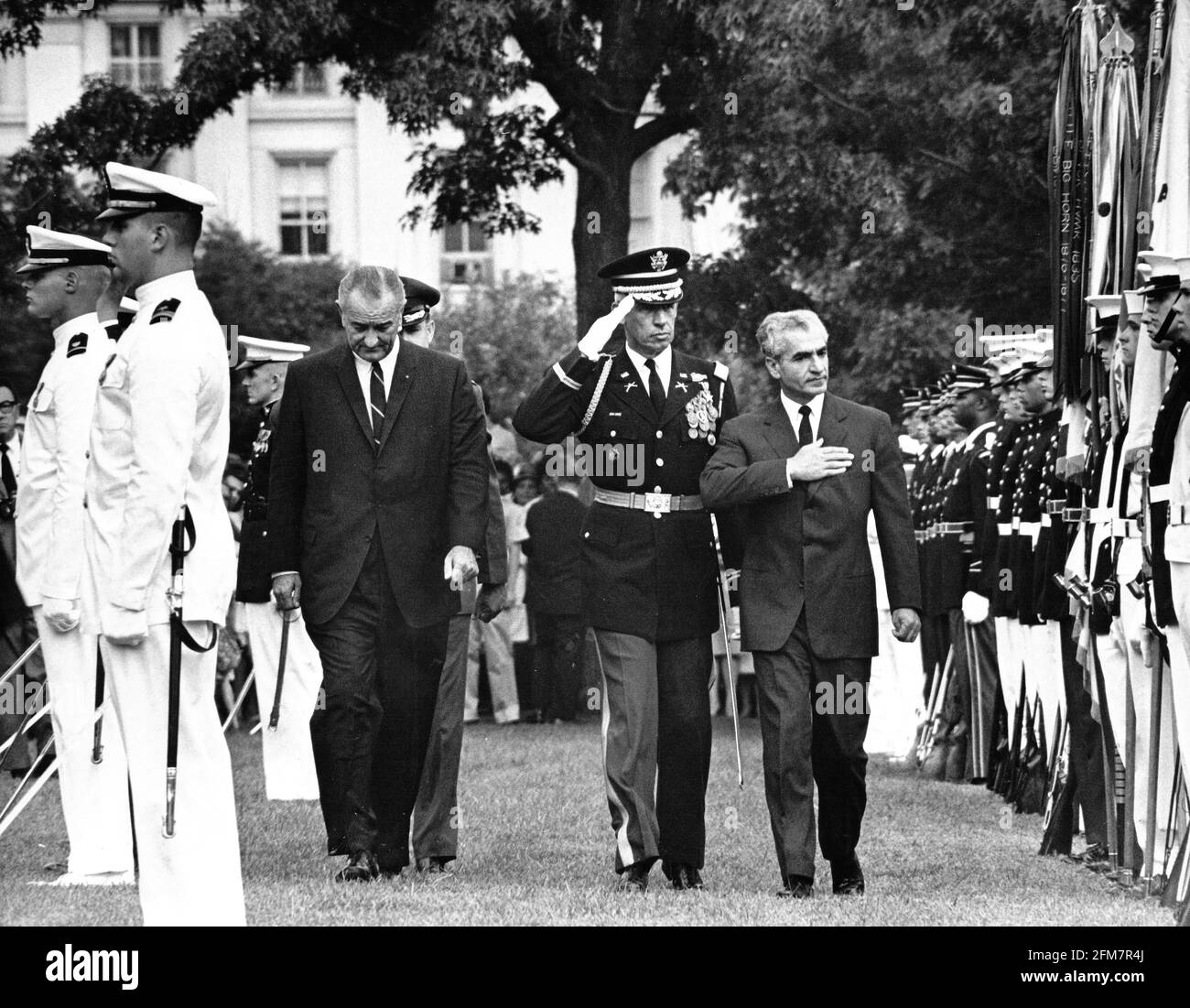 United States President Lyndon B. Johnson, left, and Commander of the Troops, US Army Colonel Joseph Conmy, Jr., center, escort Mohammad Reza Pahlavi, the Shah of Iran, right, troop the line during a full honor arrival ceremony on the South Lawn of the White House in Washington, DC on August 22, 1967. The Shah is in Washington for an informal visit.Credit: Arnie Sachs/CNP | usage worldwide Stock Photo
