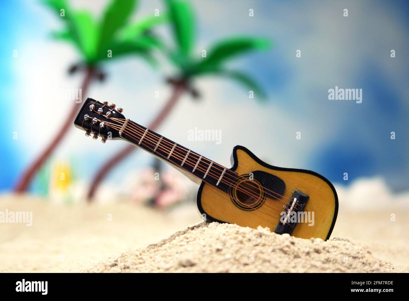 Guitar on Tropical Beach With Palm Trees in Background Stock Photo - Alamy