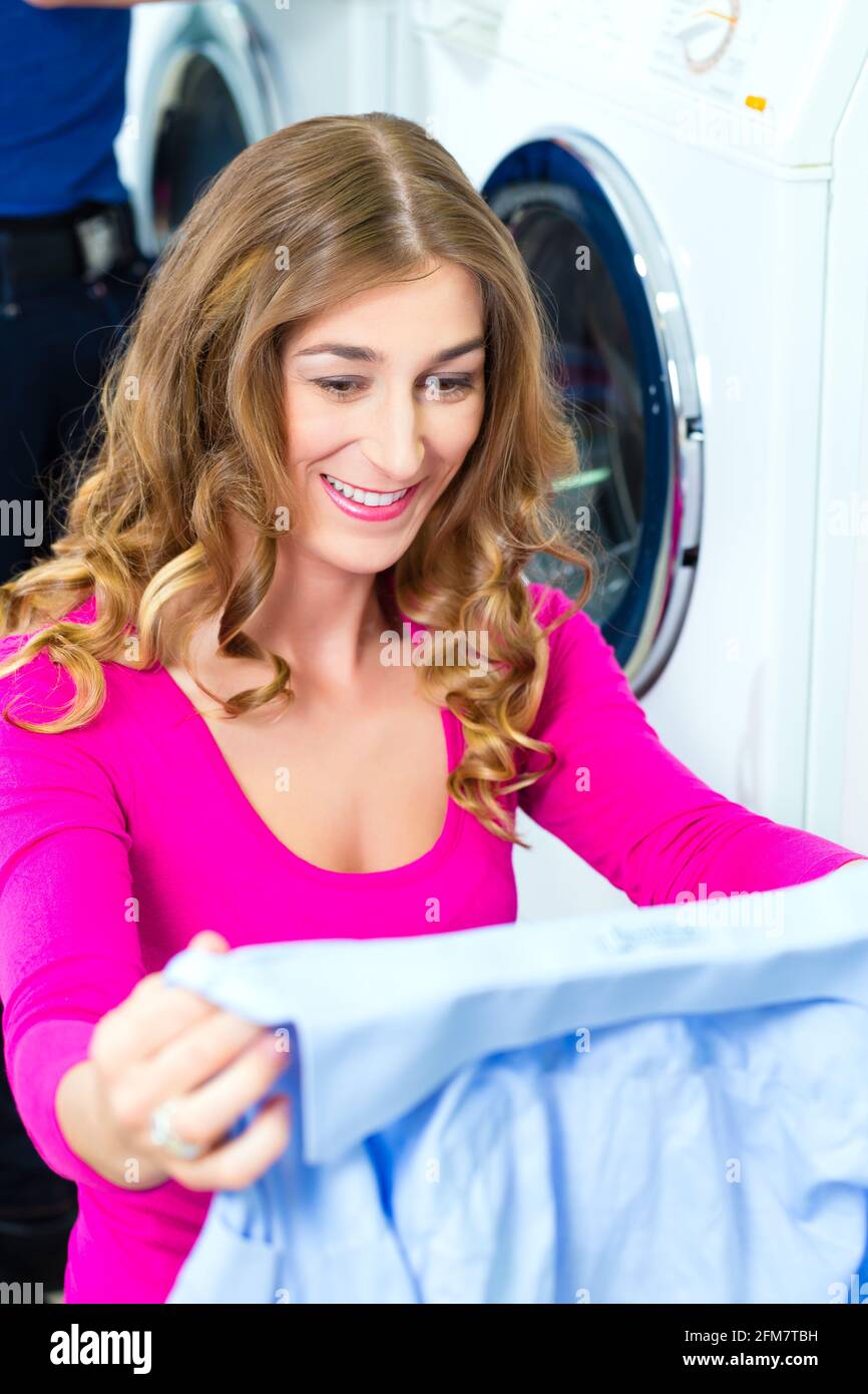 People in a launderette, washing their dirty laundry, in the background