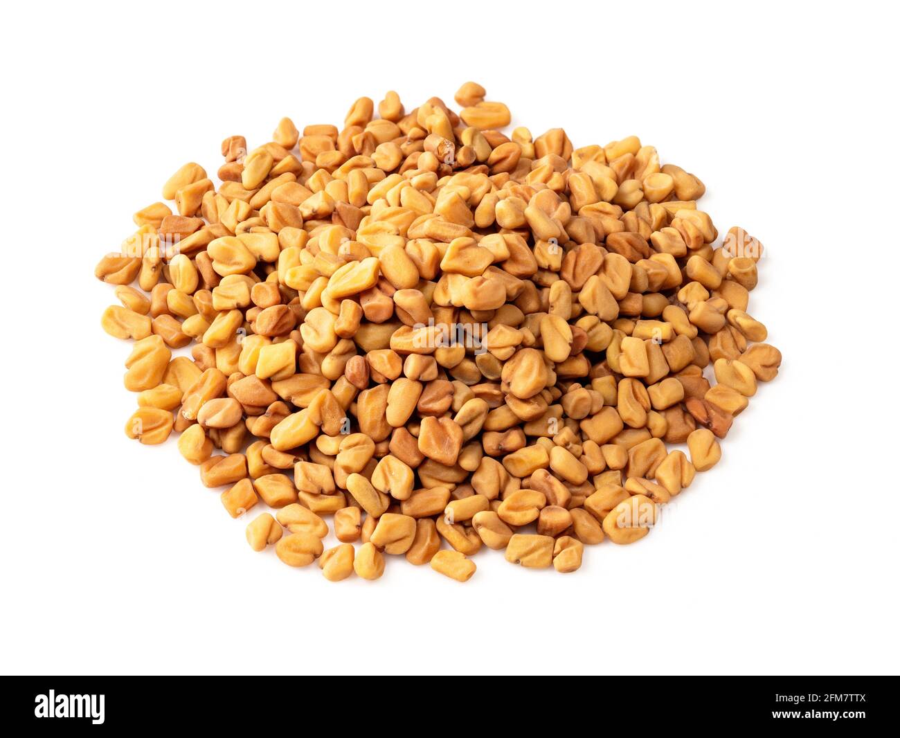 pile of Fenugreek seeds closeup on white background Stock Photo