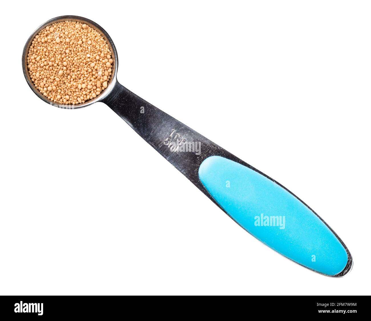 top view of granulated active dry yeast in measuring teaspoon cutout on white background Stock Photo