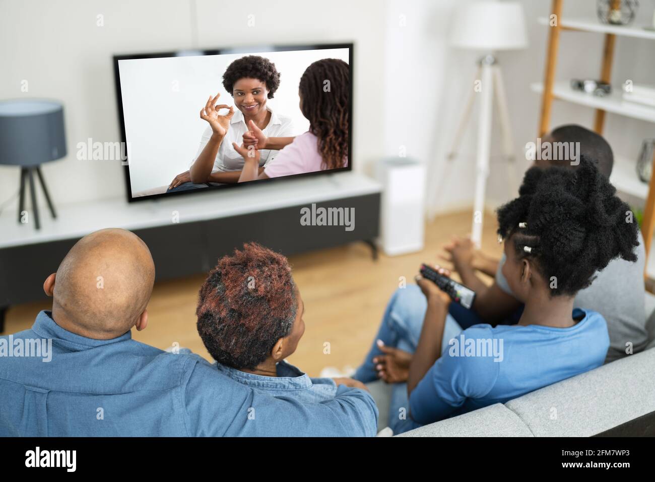 African Family Watching TV Movie On Television Stock Photo - Alamy
