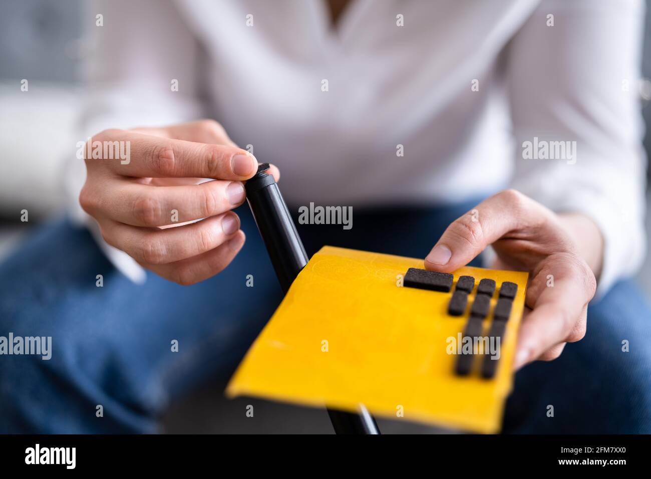 Stick Felt Pad On Chair Leg For Wooden Floor Surface Safety Stock Photo