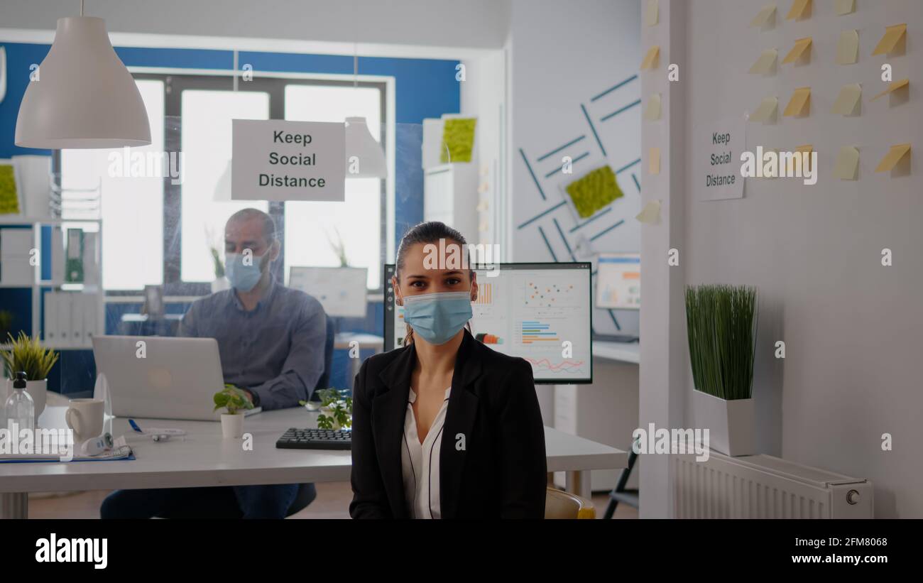 Portrait of woman manager wearing face mask to prevent infection with ...