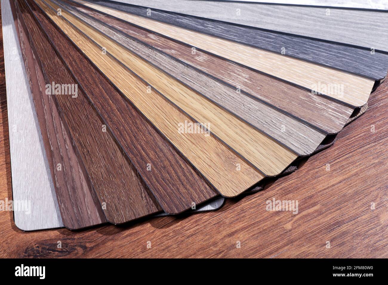 Vinyl and linoleum samples on a white isolated background. Vinyl for flooring with wood grain texture and pattern. High quality photo Stock Photo