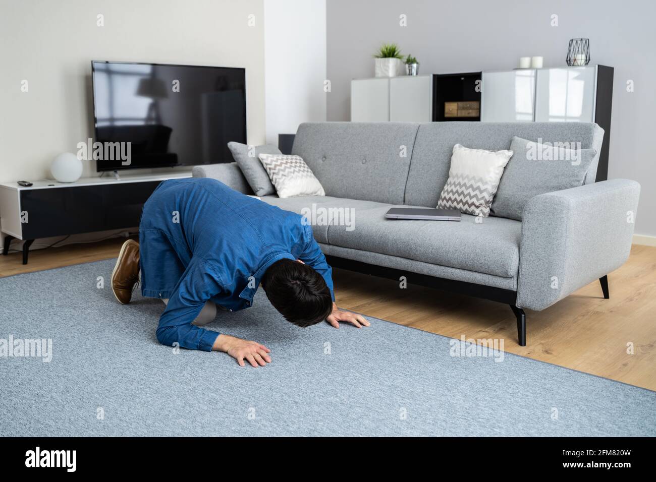 Man Looking For Lost Keys Or Searching Something Stock Photo