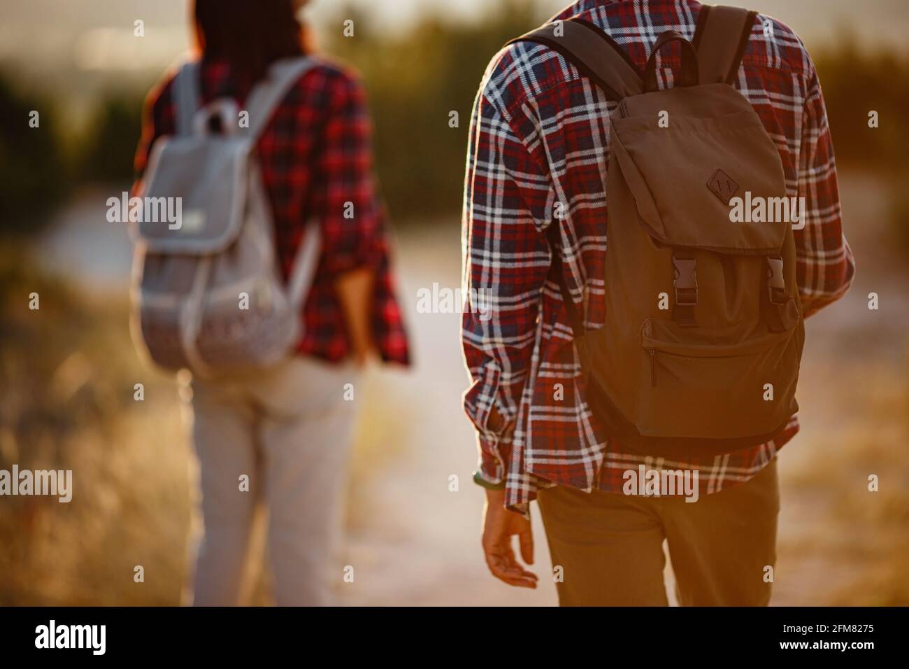 Portrait of happy young couple having fun on their hiking trip ...