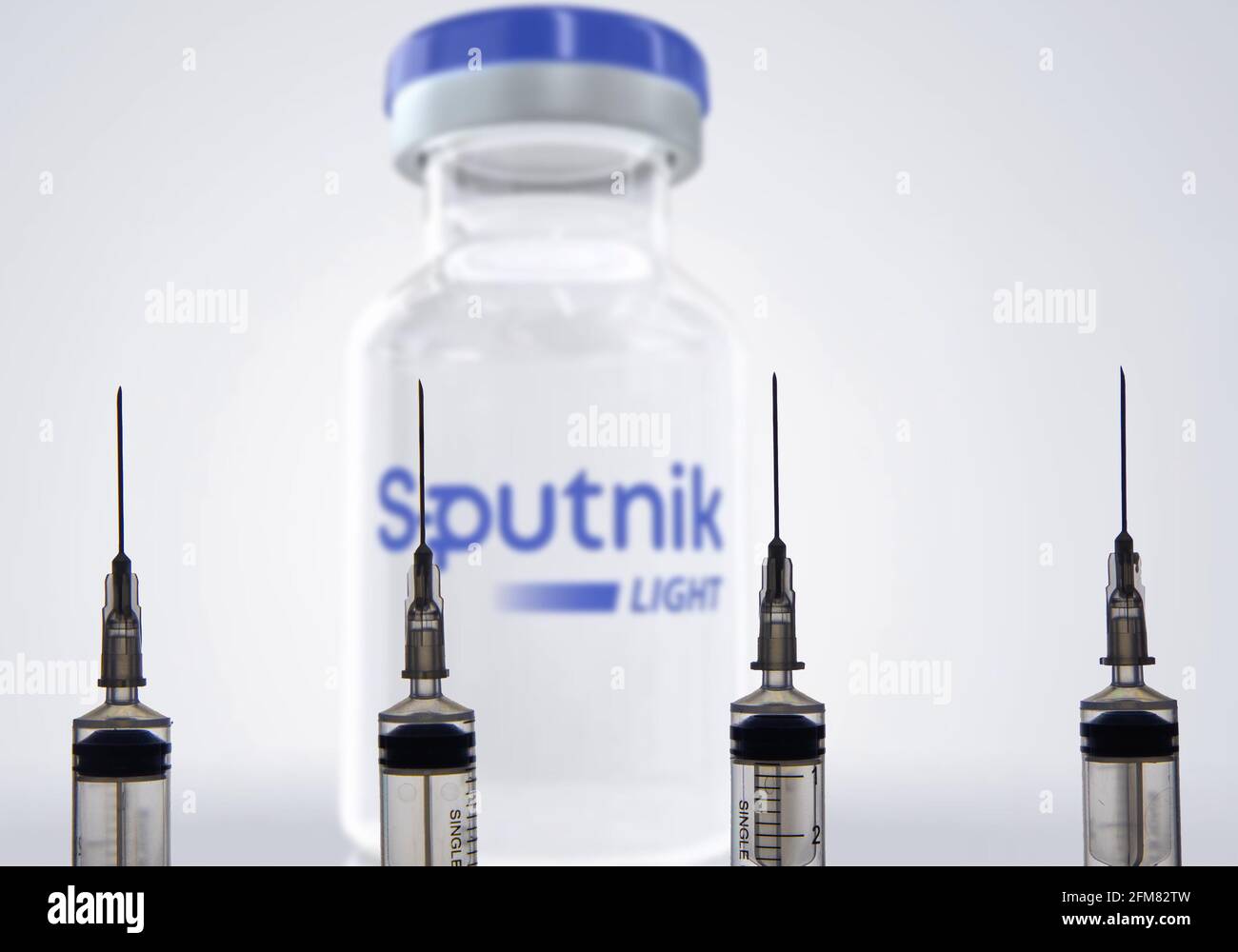 Kathmandu, Nepal - January 03 2021: Closeup of a syringe against Sputnik Light Vial. Stock Photo