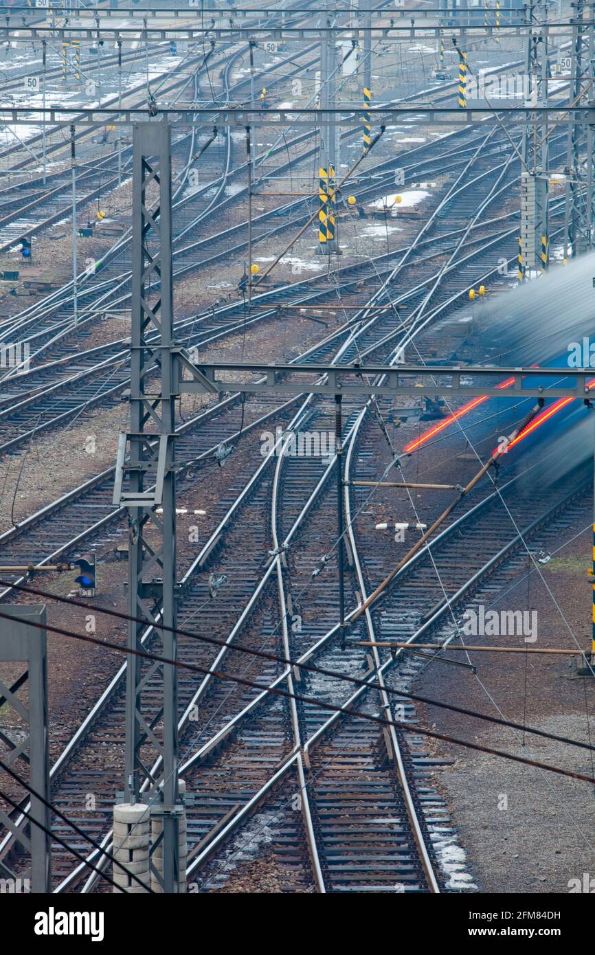 Train moving fast on railroad rails - view from above. Stock Photo