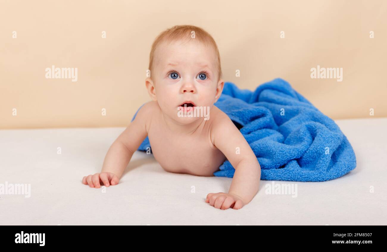 Cute baby is wearing diaper. Bathing and washing of little kids Stock