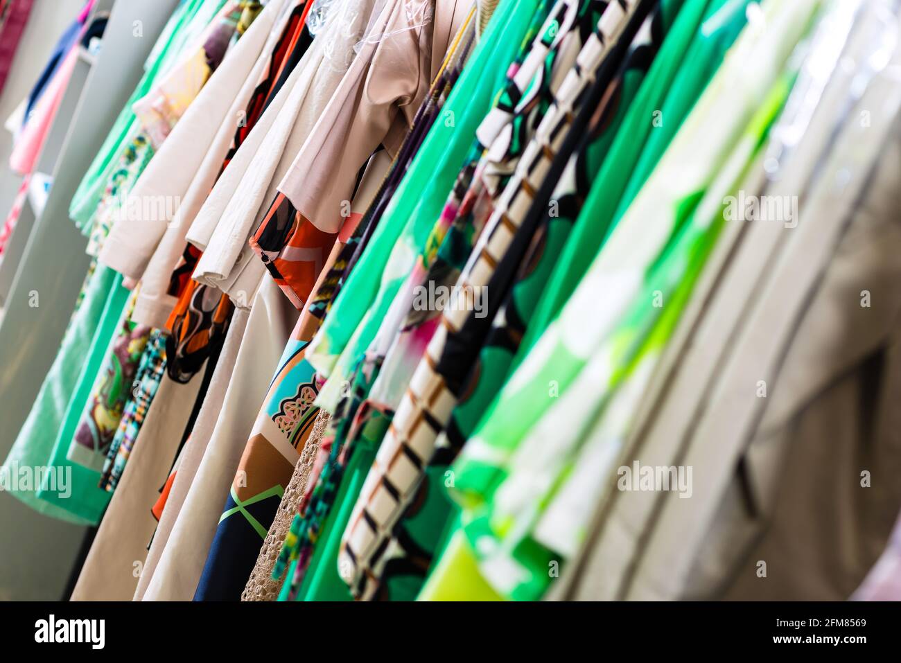 Selection of many fashionable dresses in a department store or shop