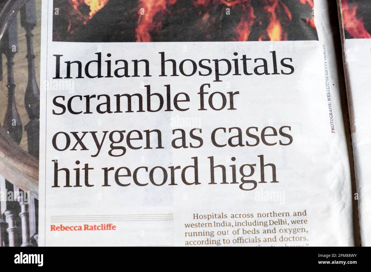 'Indian hospitals scramble for oxygen as cases hit record high' Guardian newspaper coronavirus India pandemic covid article inside page London UK 2021 Stock Photo