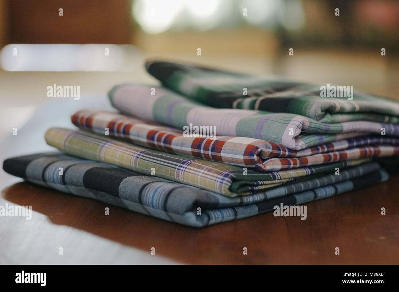 Square pattern of Indonesian sarung for Muslim men doing prayer Stock Photo